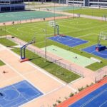 Complexo esportivo em Brasília com quadras e campos para diversos esportes, representando vagas gratuitas na Vila dos Campeões no DF.