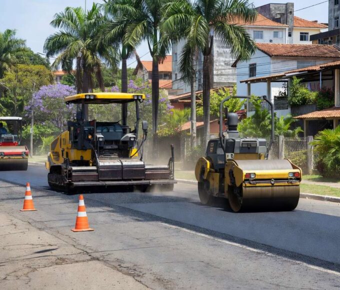 Obras de recapeamento asfáltico na Avenida Del Lago no Itapoã, com máquinas e sinalizações de trânsito.