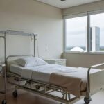 Quarto de hospital em Brasília com cama e equipamentos médicos, representando dedicação em cuidados após cirurgia no DF.